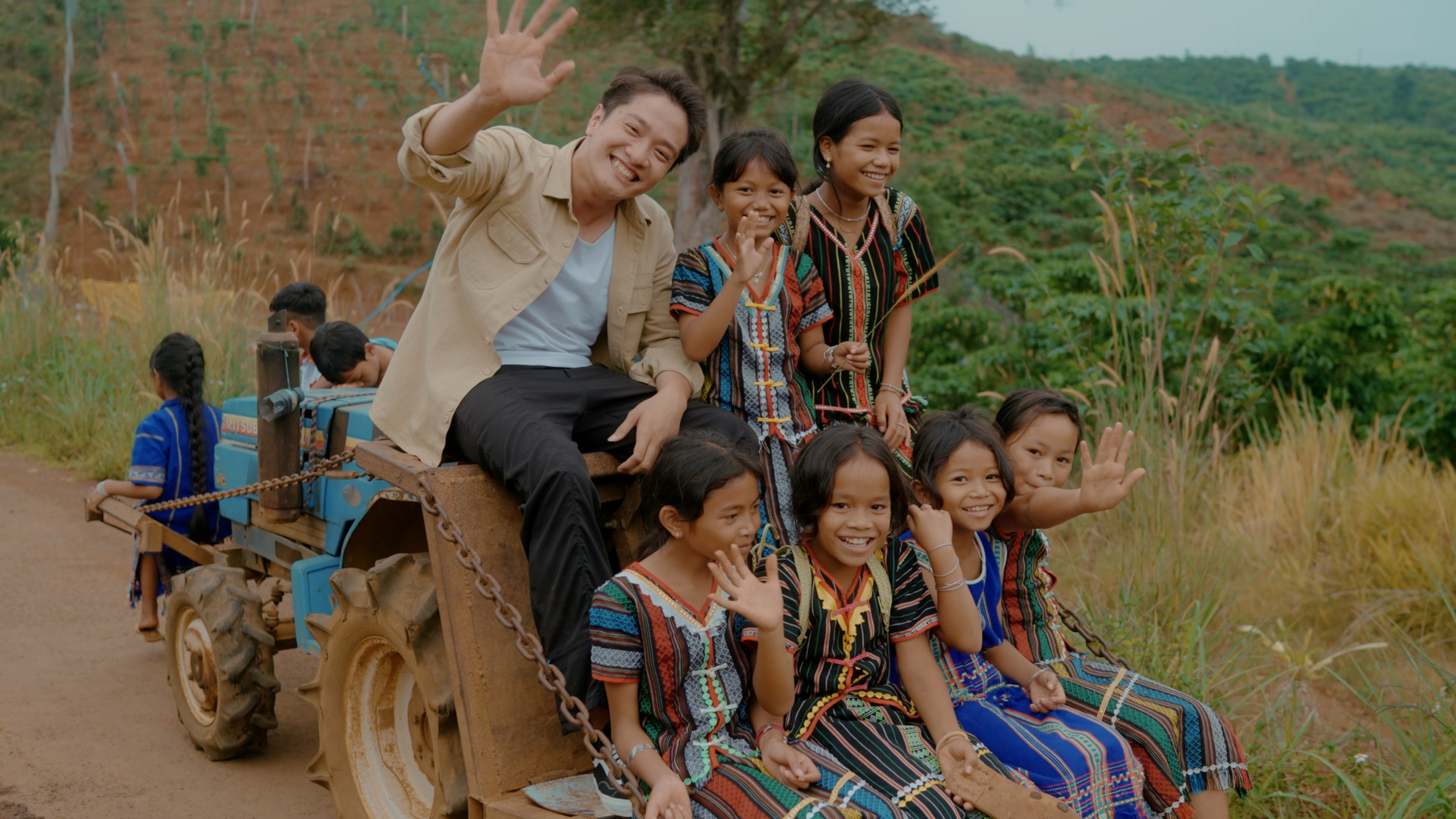 A person and children on a tractorDescription automatically generated